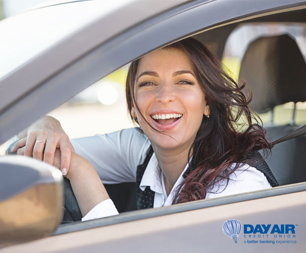 Woman smiling driving a car